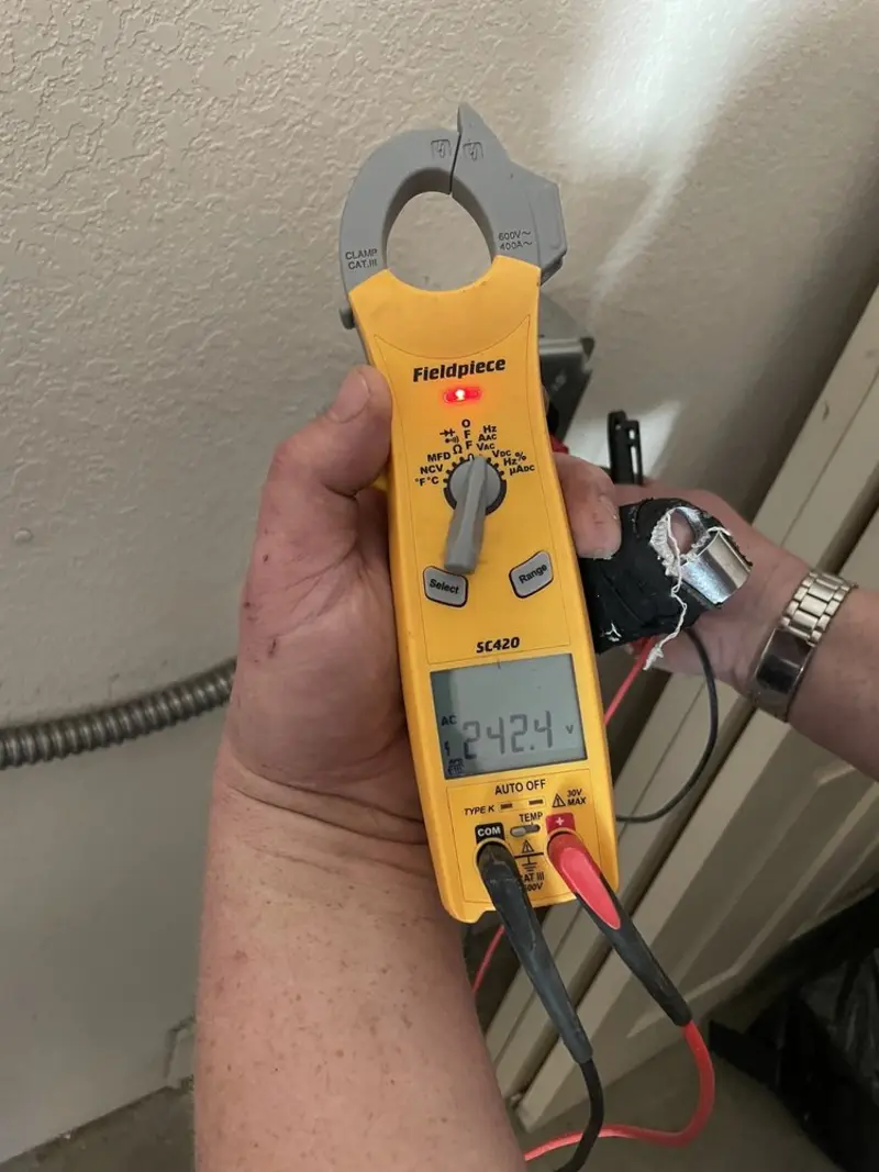 Voltage testing with clamp meter during Electrical Installation Services in Emmett